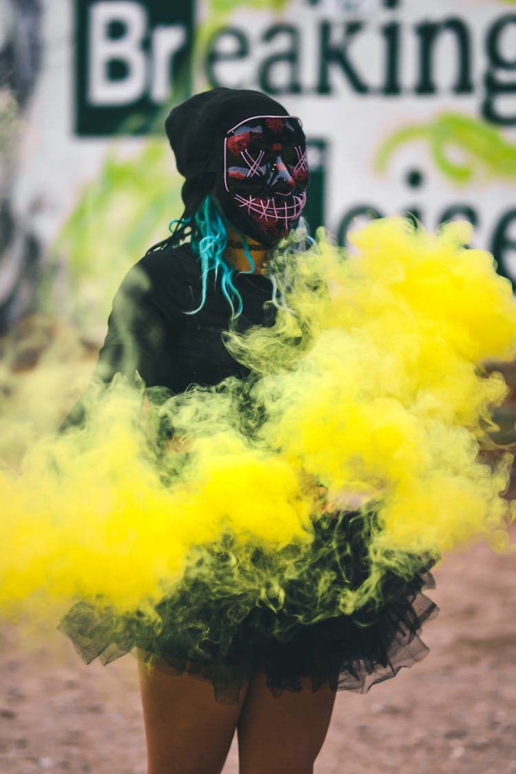 Woman Wearing Mask With Yellow Smoke