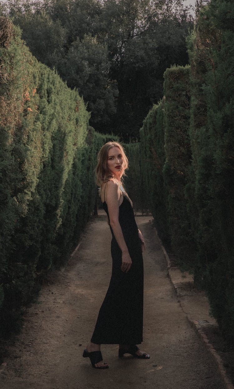 Woman In Alley In Hedge Garden