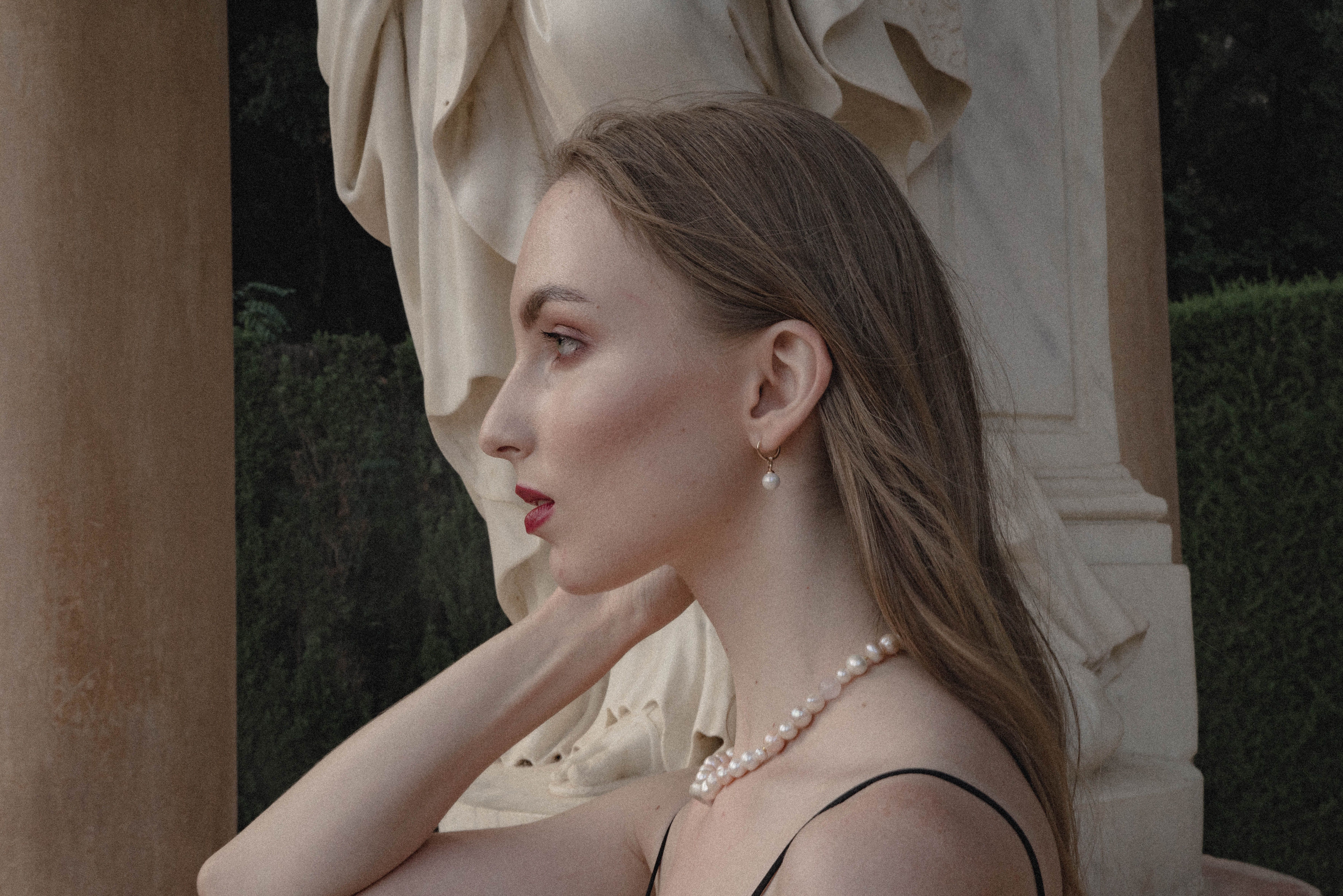 A Woman Wearing Pearl Earring and Pearl Necklace · Free Stock Photo
