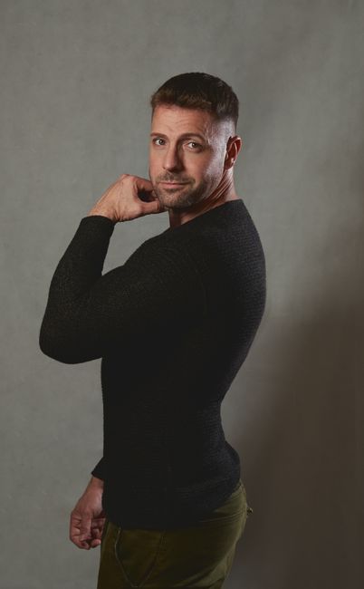 Man posing confidently in a studio setting, showcasing fashion and style. Man posing confidently in a studio setting, showcasing fashion and style.