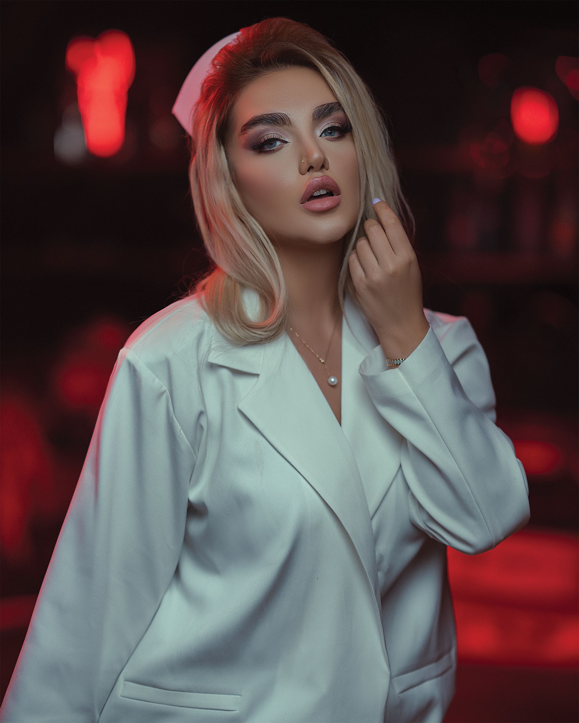 Elegant portrait of a young woman in a fashionable white outfit with a captivating pose.