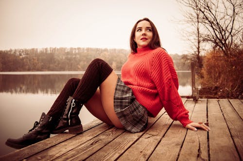 Free Sexy Woman Sitting on a Wooden Dock Stock Photo
