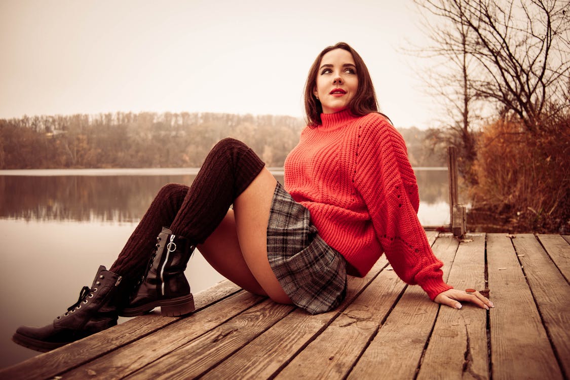 Sexy Woman Sitting on a Wooden Dock