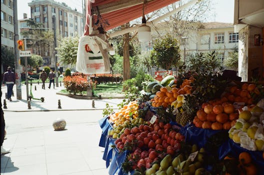 A bustling outdoor street market with fresh fruits display in Istanbul, Turkey.