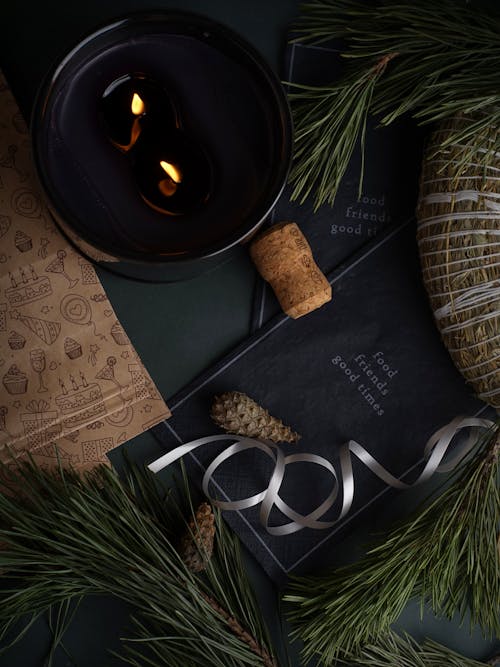 Dark Still Life with a Black Candle and Pine Tree Branch with Cones