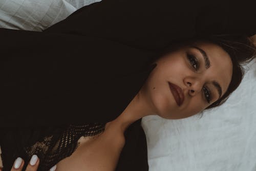Free Beautiful Woman Lying Down on Bed Stock Photo