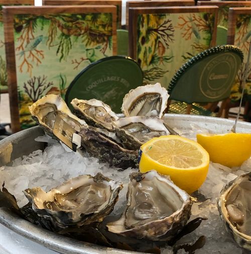 Free Delicious raw oysters served on ice with lemon slices in a Cannes restaurant. Stock Photo