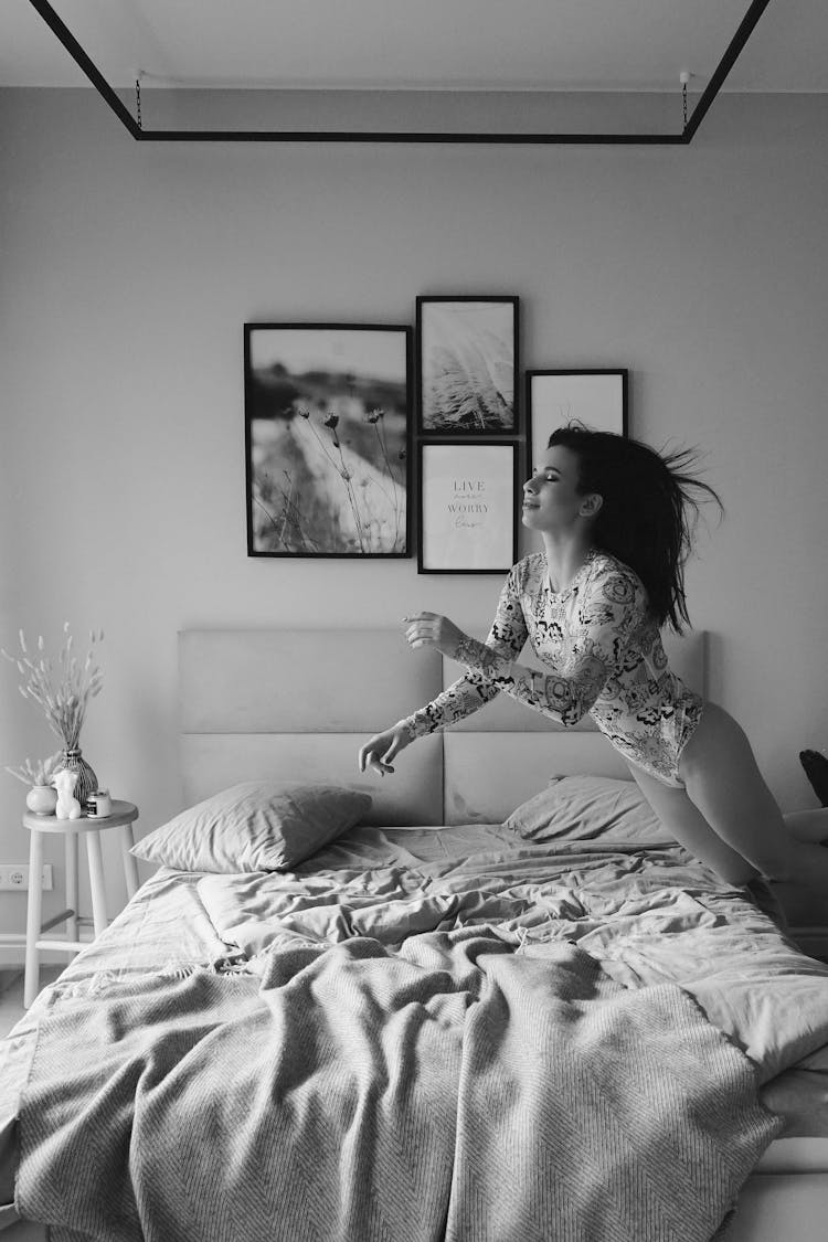 Woman Jumping On Bed