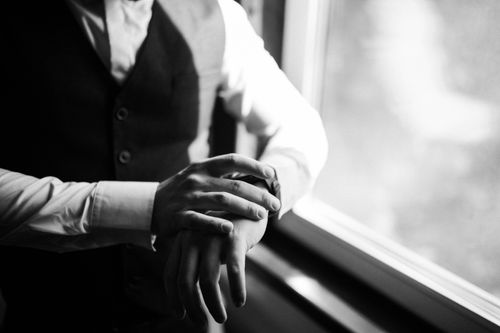 Free A monochrome image captures a man's hands adjusting a watch, exuding elegance and sophistication. Stock Photo