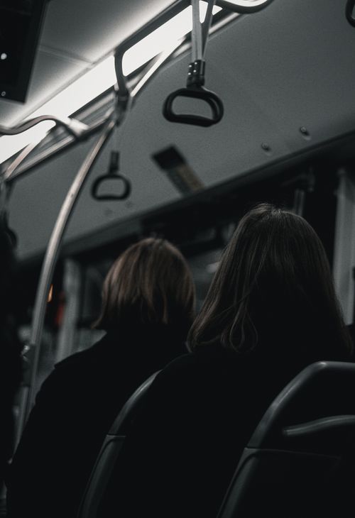 Free Dimly lit bus interior with passengers seated, capturing a moody urban atmosphere. Stock Photo