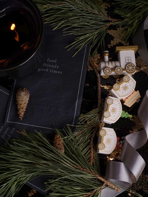 Christmas Flat Lay of Candle, Handkerchief, Toy Train and Twigs