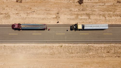 Free Drone shot of two trucks on a rural road in Independencia, Paraguay. Stock Photo