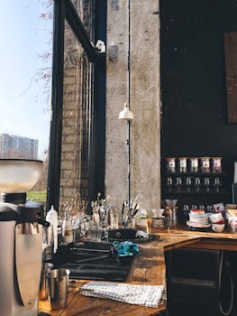 Sunlit café interior with wooden counter and coffee equipment, perfect urban setting.