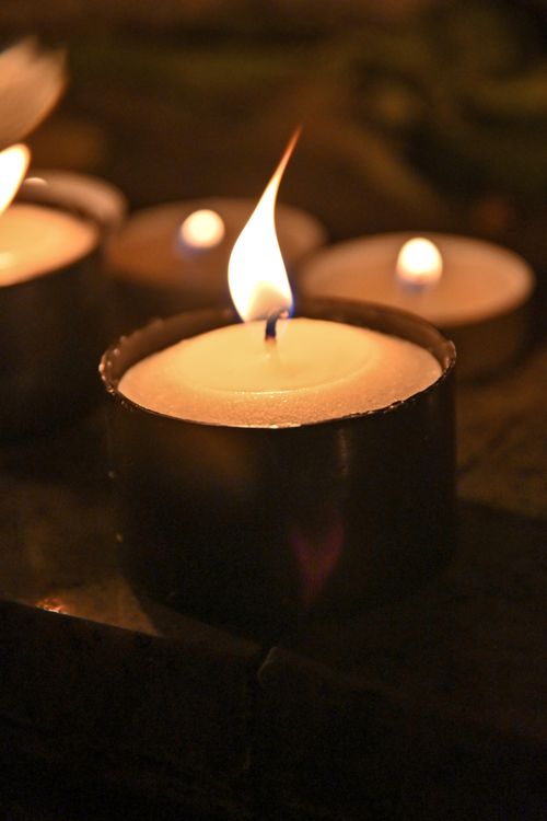 Free Close-up of a lit candle creating a warm and cozy ambiance, perfect for relaxation and meditation. Stock Photo