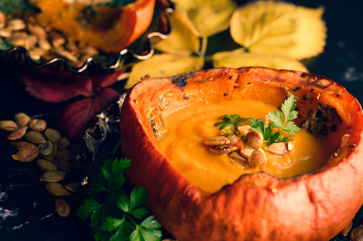 Creamy pumpkin soup served in a pumpkin bowl