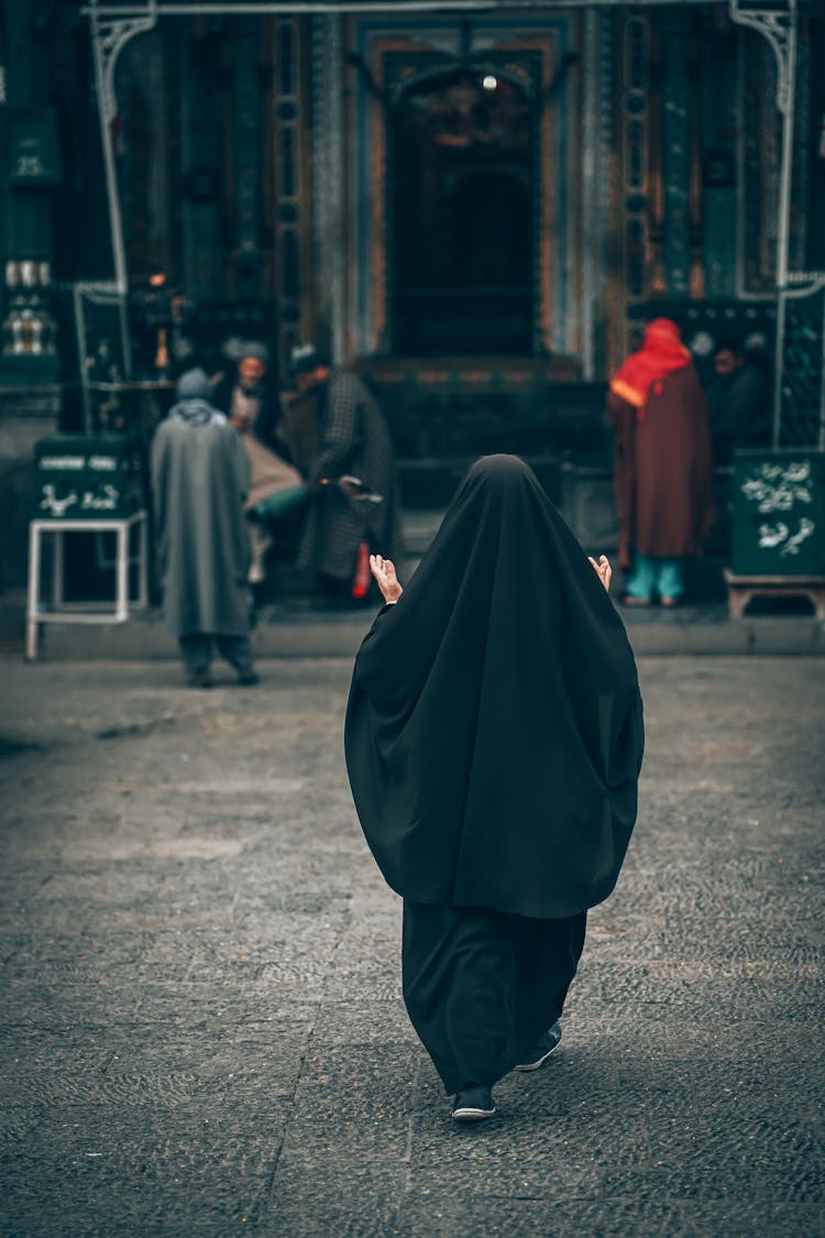 A Woman In Black Abaya Praying