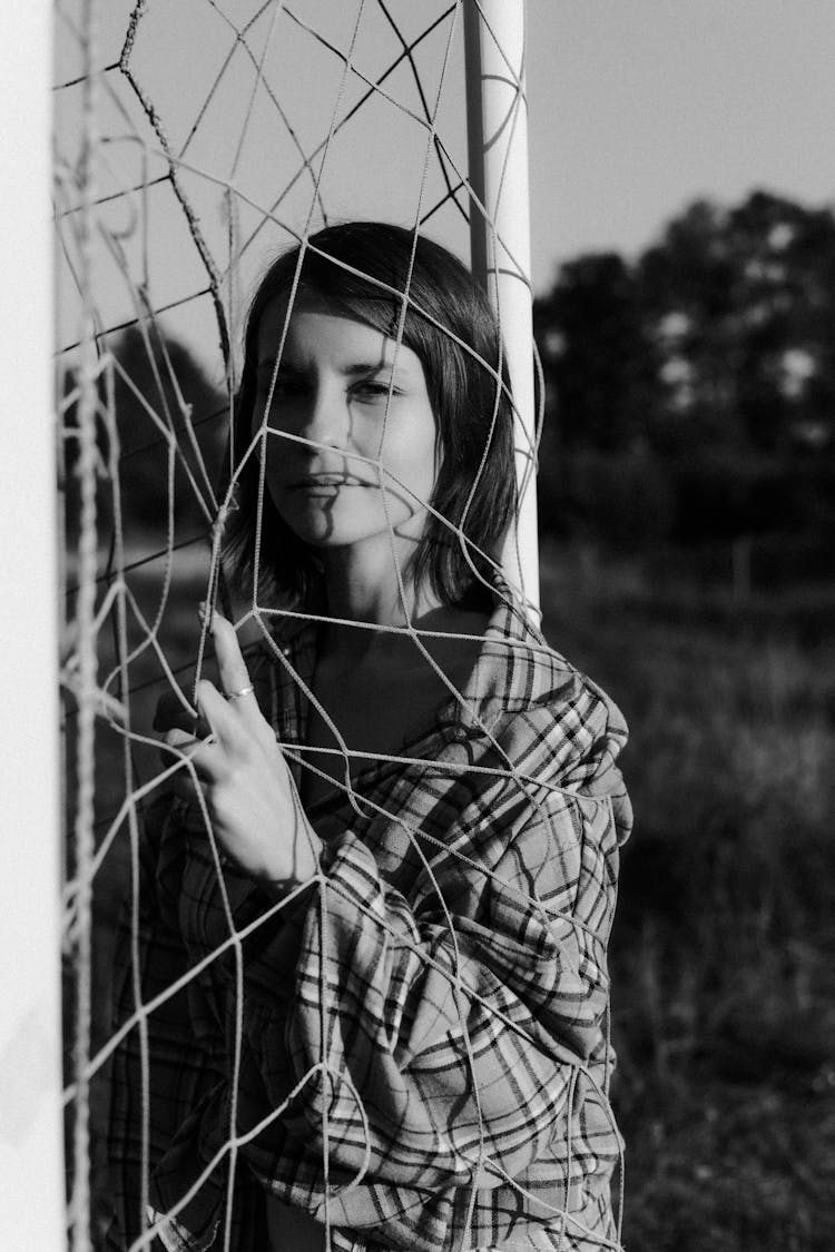 A Woman Inside A Soccer Goal Post