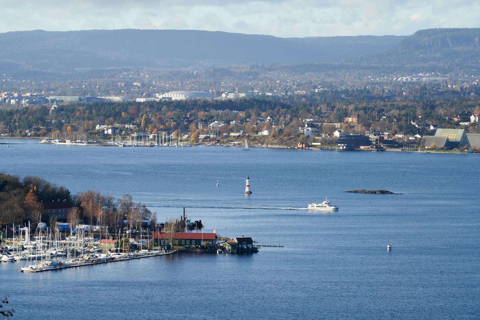 Breathtaking view of Oslo Fjord with marina and cityscape in the background, showcasing watercraft and landscape.