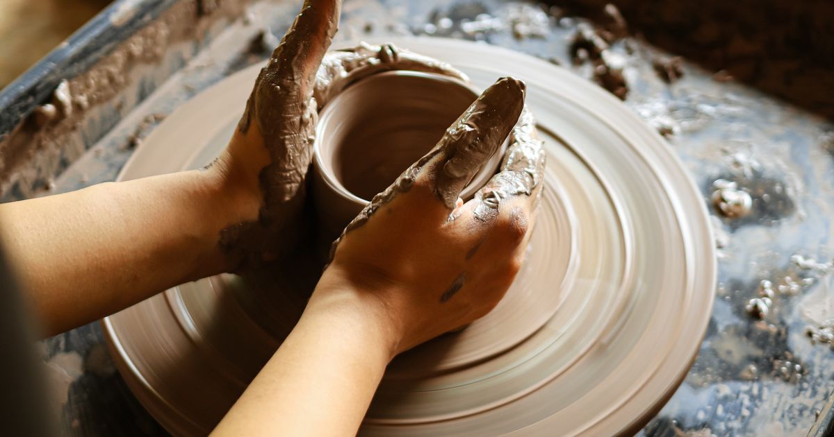 A potter's hands shaping clay on a spinning wheel, representing the innate gifts revealed by the Destiny Matrix talents zone