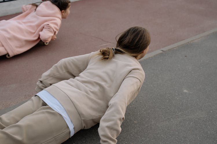 A Woman And A Young Girl Doing Exercise Together