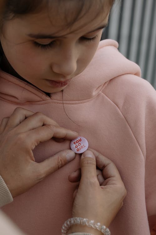 A Person Holding a Pink Badge