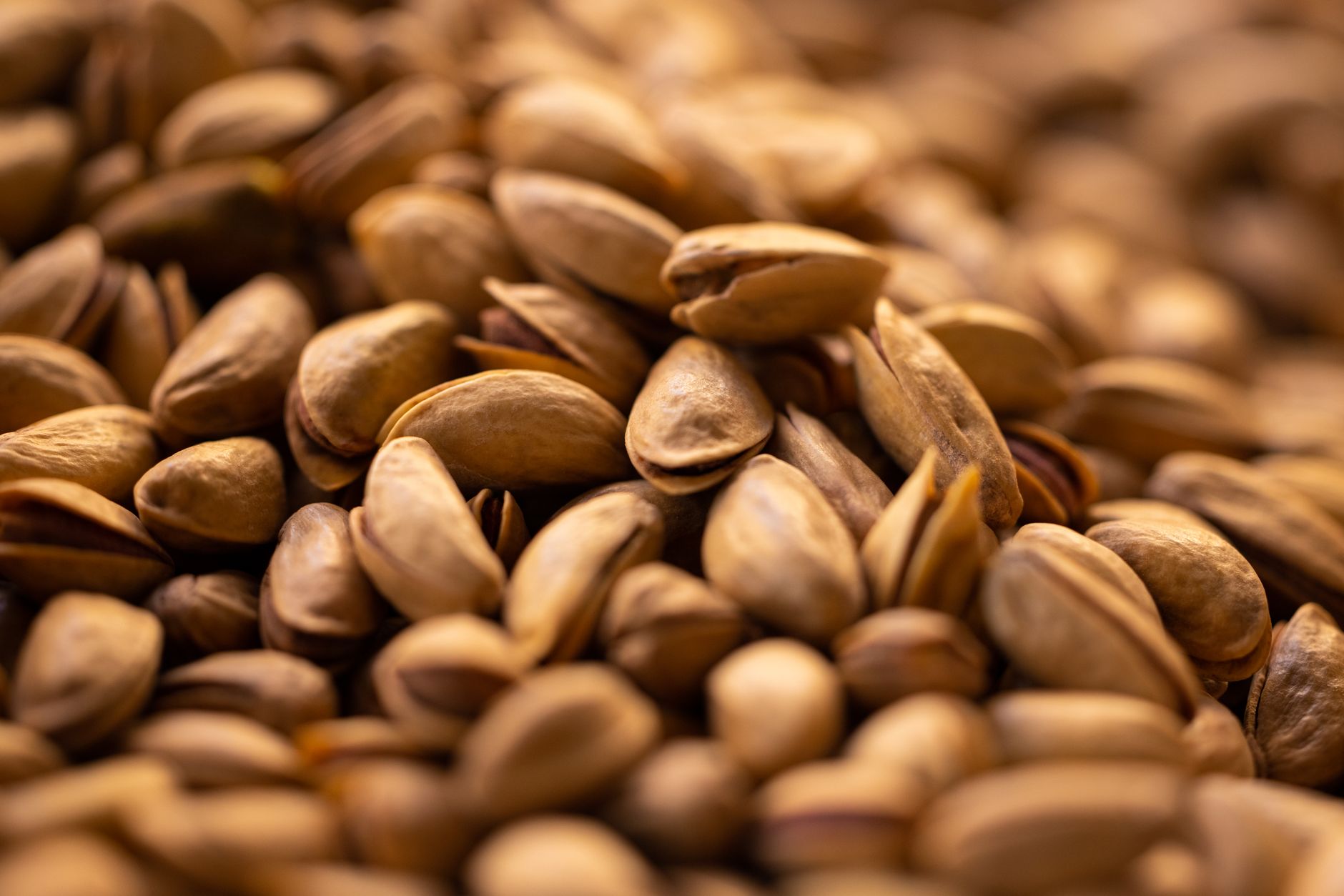 Roasted pistachios in a rustic bowl