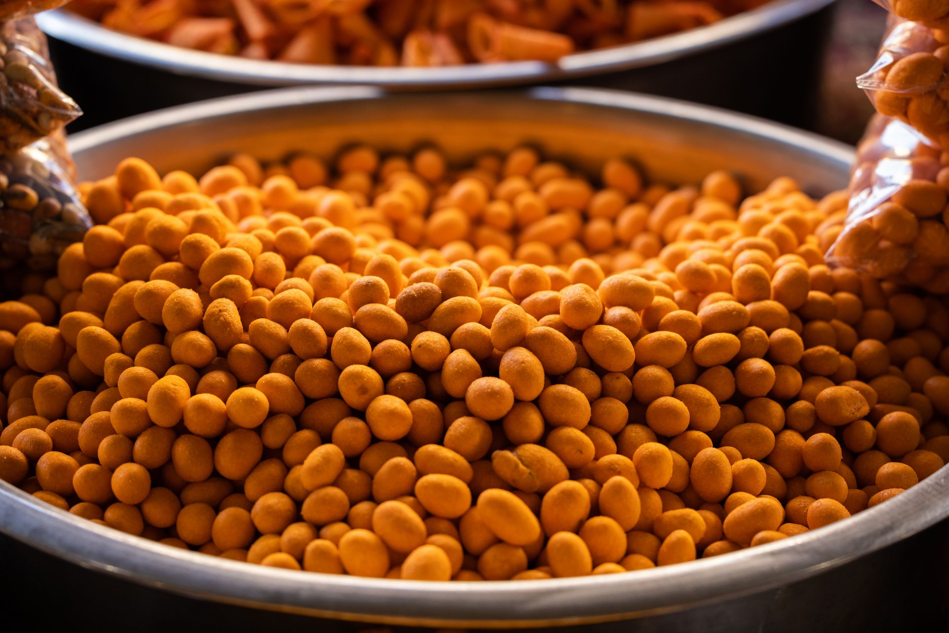 Delicious roasted chickpeas in a metal bowl, showcasing vibrant orange color and healthy snack appeal.