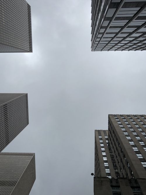 Free A dramatic view of New York City skyscrapers under a gloomy sky. Stock Photo