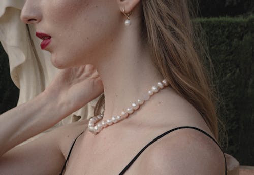 A Woman in Pearl Necklace and Earring