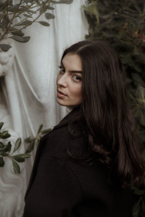 Woman in Black Coat Looking Over Her Shoulder