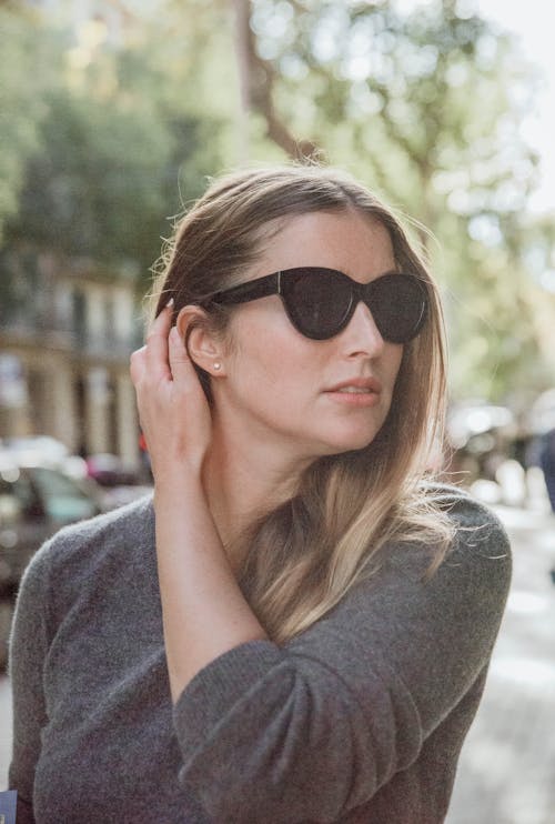 Woman in Gray Long Sleeve Shirt Wearing Black Sunglasses