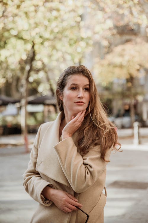 A Brunette Wearing a Brown Coat