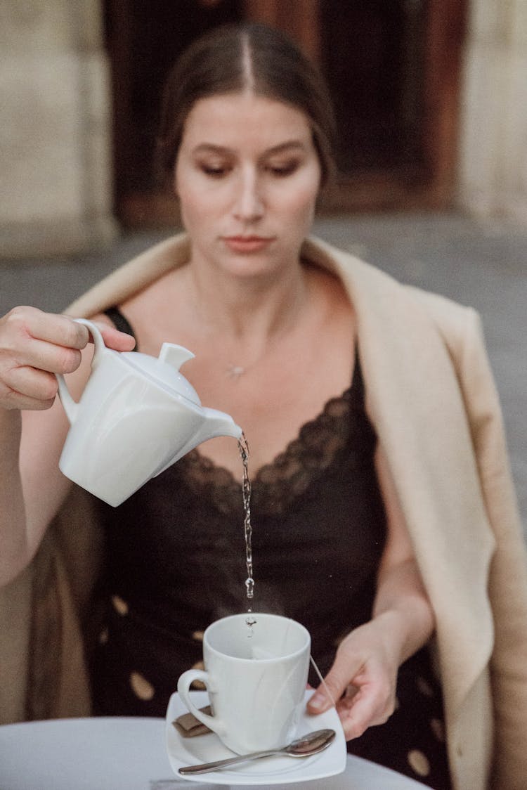 Woman Pouring Water To Glass