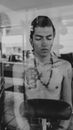 A Male in Tattoos Behind The Glass 