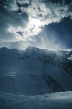Misty and dramatic mountain landscape in Furna, Switzerland, with snow and winter sky.