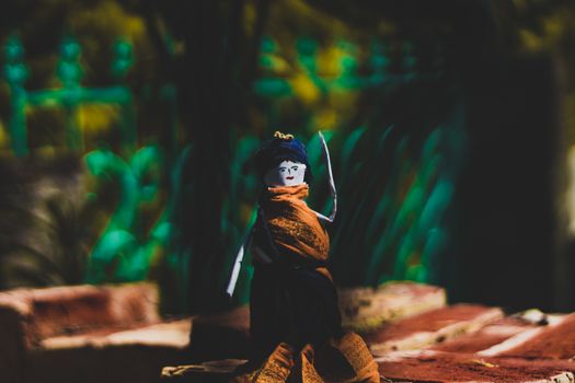 A handcrafted origami doll showcased in an outdoor setting, capturing artistic detail.