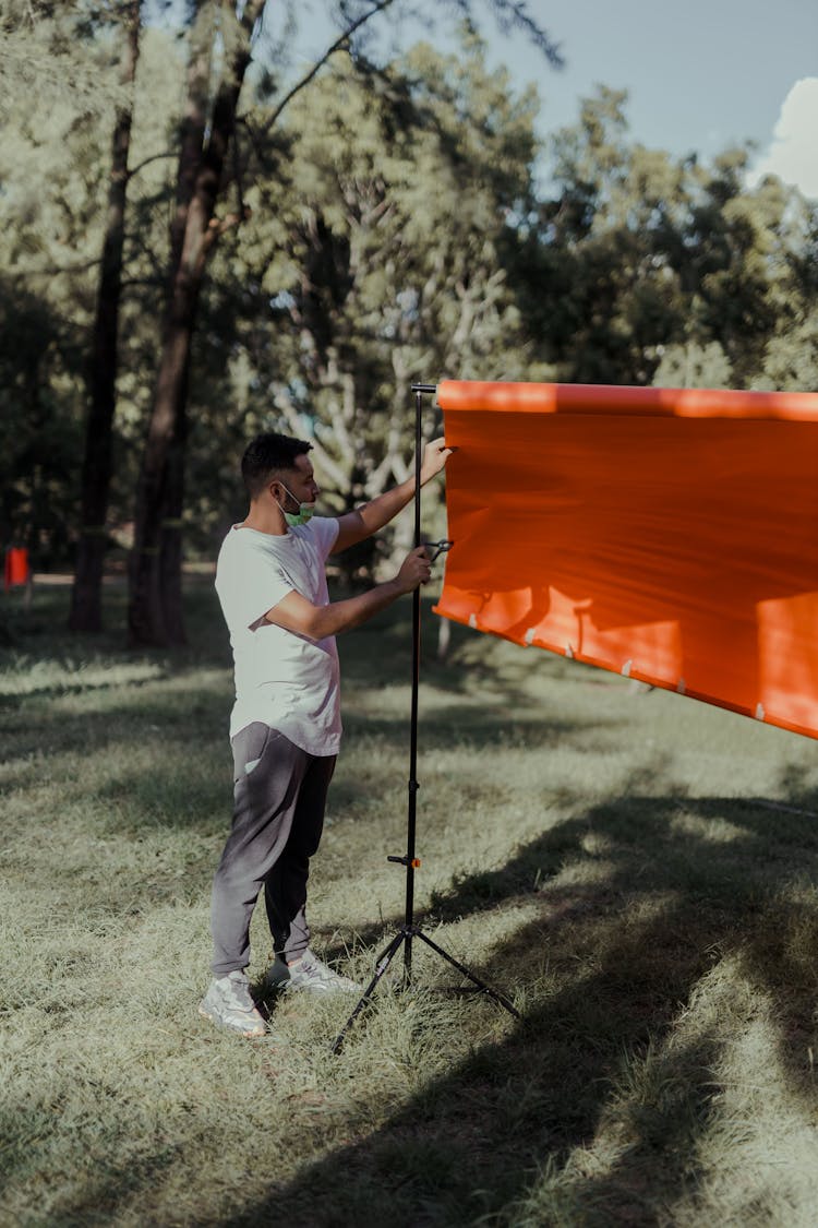 Man Putting Up A Banner Stand