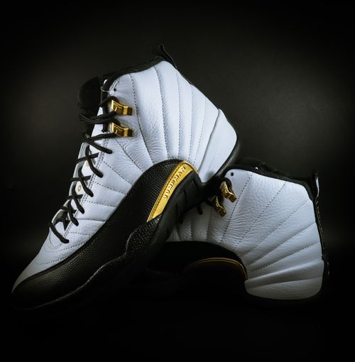 Free Close-up of stylish black and white sneakers featuring gold accents, ideal for fashion enthusiasts and sneaker collectors. Stock Photo