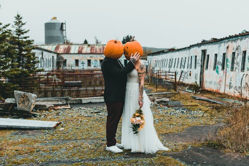 Bride and Groom with Pumpkins on their Heads 