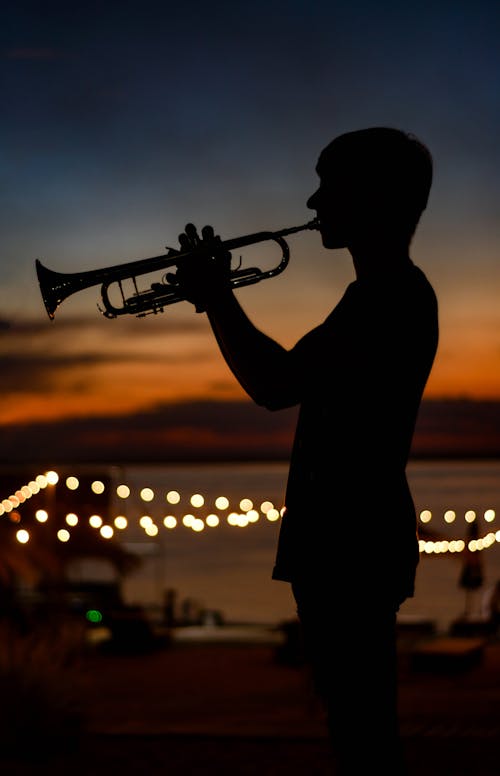 Silhouette of a Person Playing Trumpet
