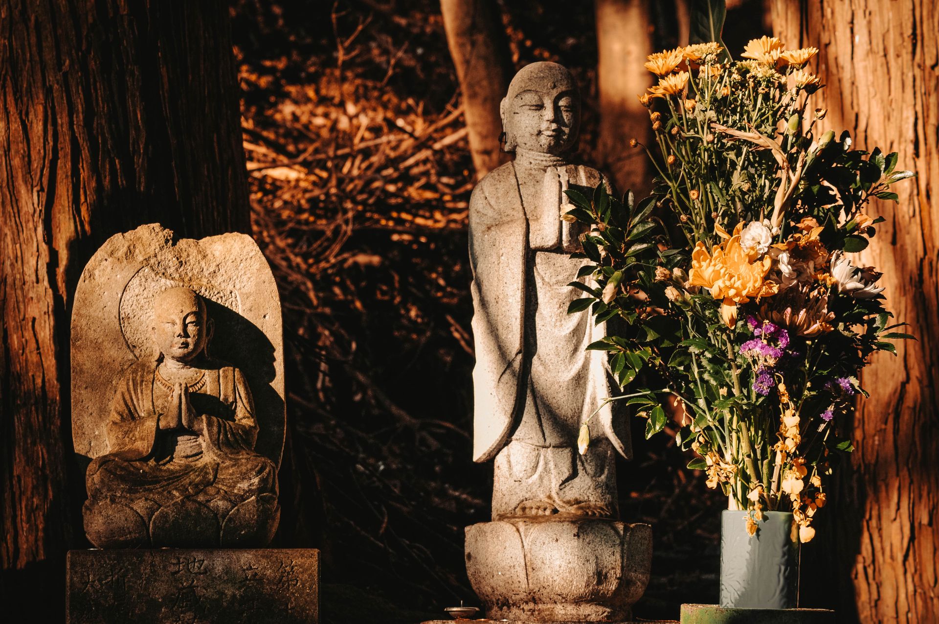 Concrete Buddha Statues and Flowers