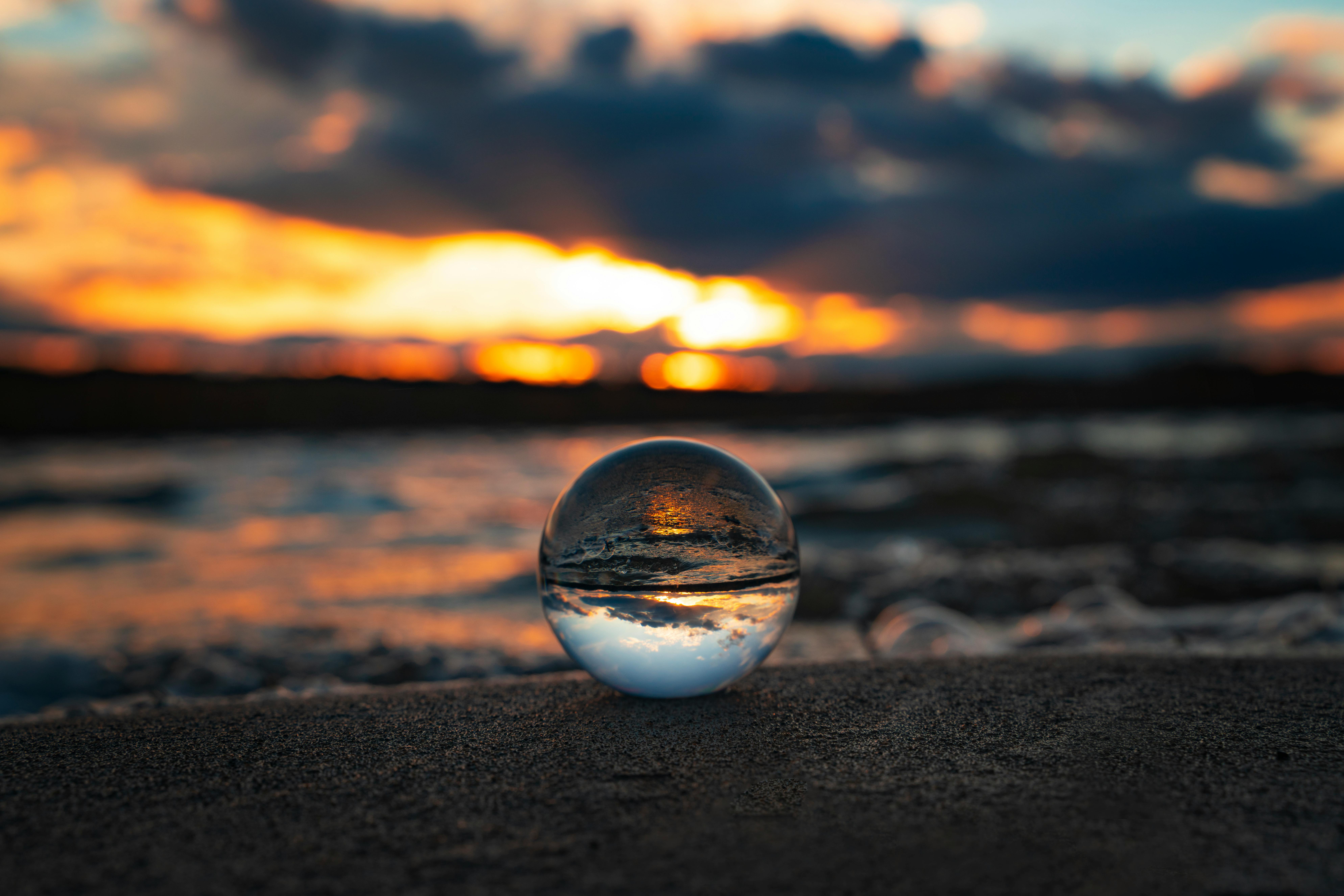 CloseUp Photo of a Clear Ball on Beach Sand · Free Stock Photo