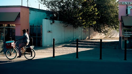 Man Riding Bike on City Street