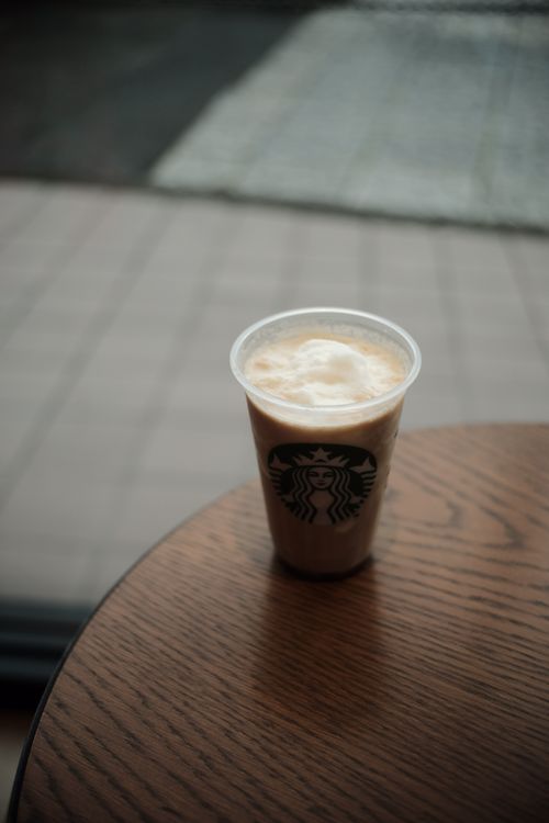 Free A refreshing iced coffee in a plastic cup on a wooden table indoors. Stock Photo