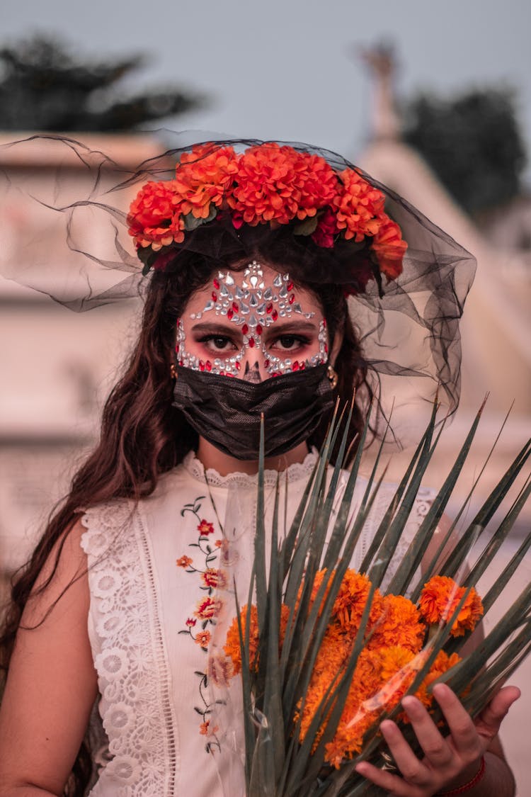Woman With Flowers And Decorations On Face