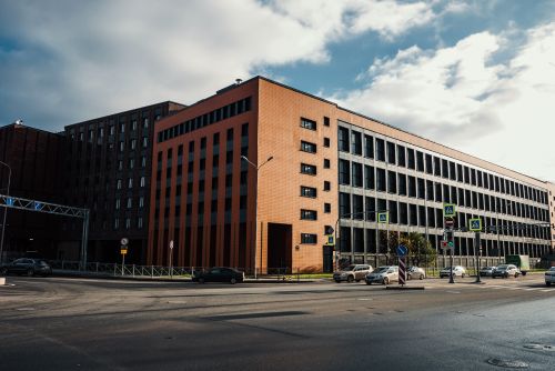 Free Cityscape featuring modern building facades and street activity on a sunny day. Stock Photo