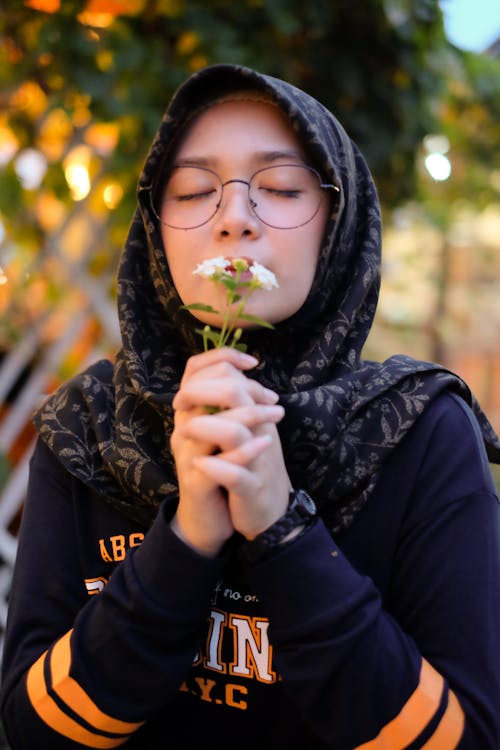 Free Photo of Girl Smelling White Petaled Flowers Stock Photo