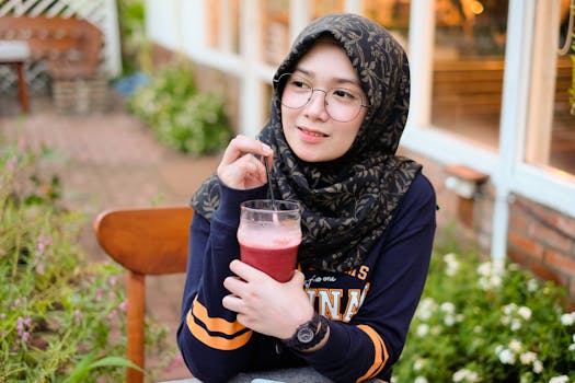 Woman Holding Cup of Red Juice