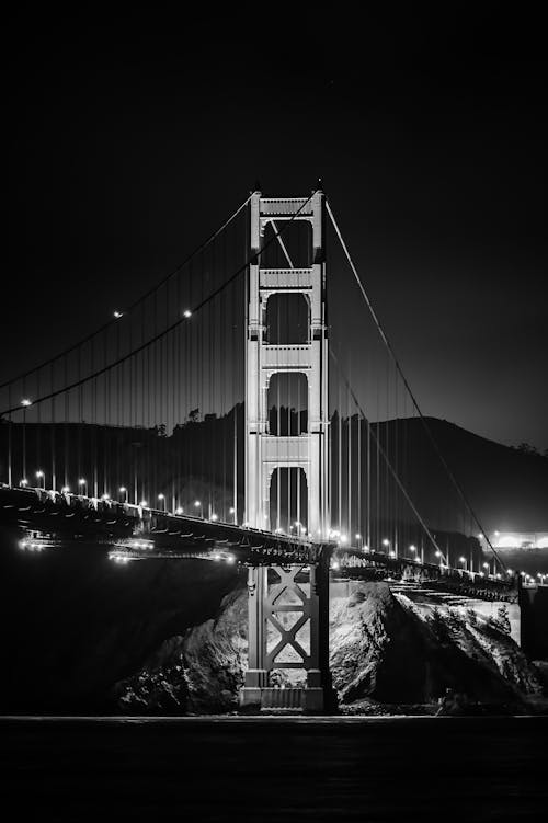 Grayscale Photo of a Suspension Bridge