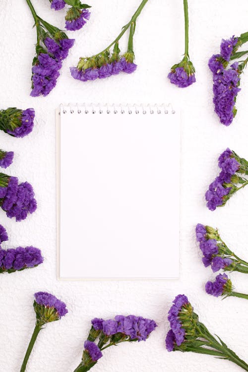 Purple Flowers Around a Blank Notepad